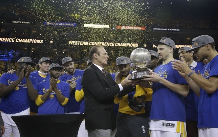 Former NBA player Rick Barry, center, presents the Western Conference finals trophy to Golden State Warriors guard Klay Thompson