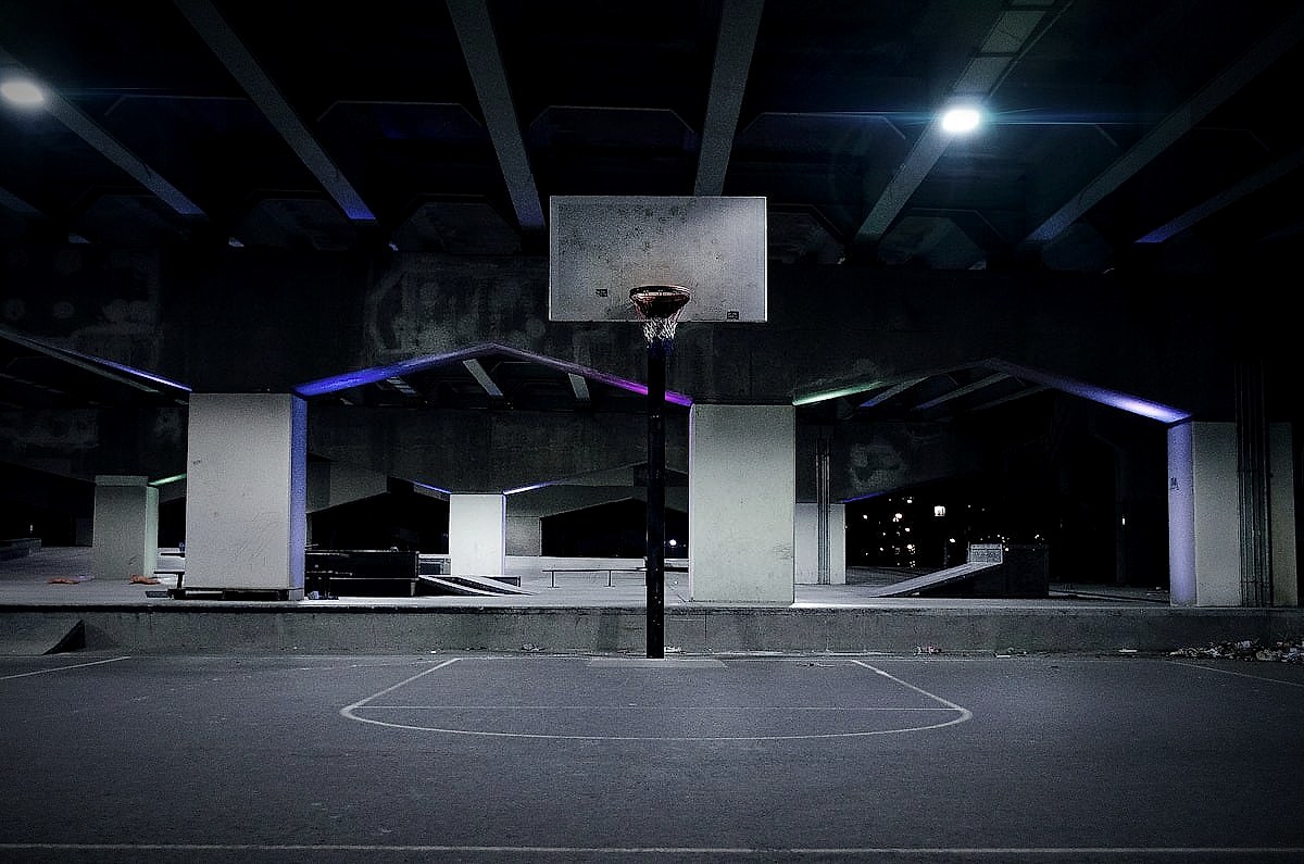 A basketball court photographed at night