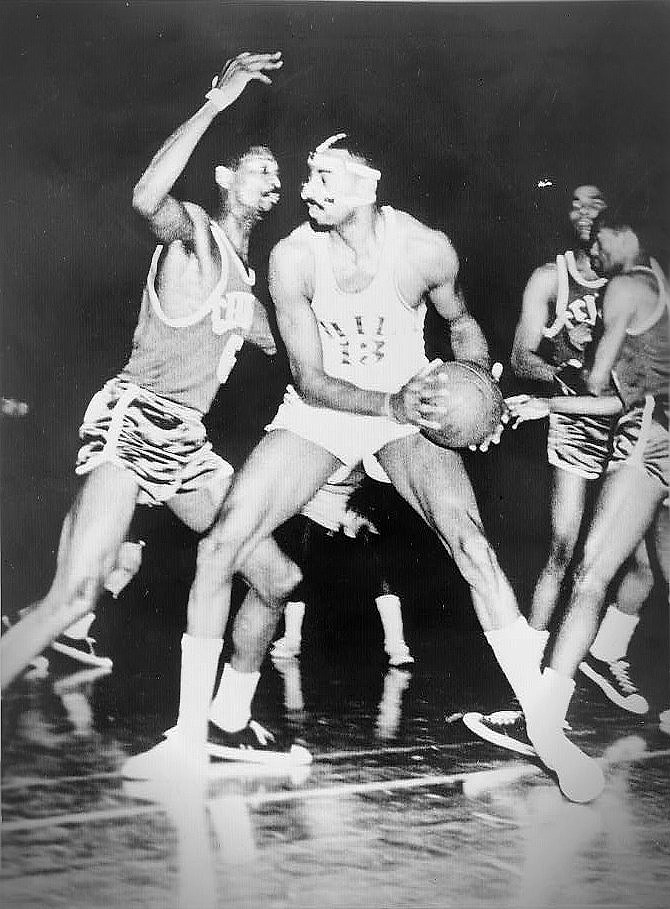 Wilt Chamberlain and Bill Russell facing off during a 1960s NBA game