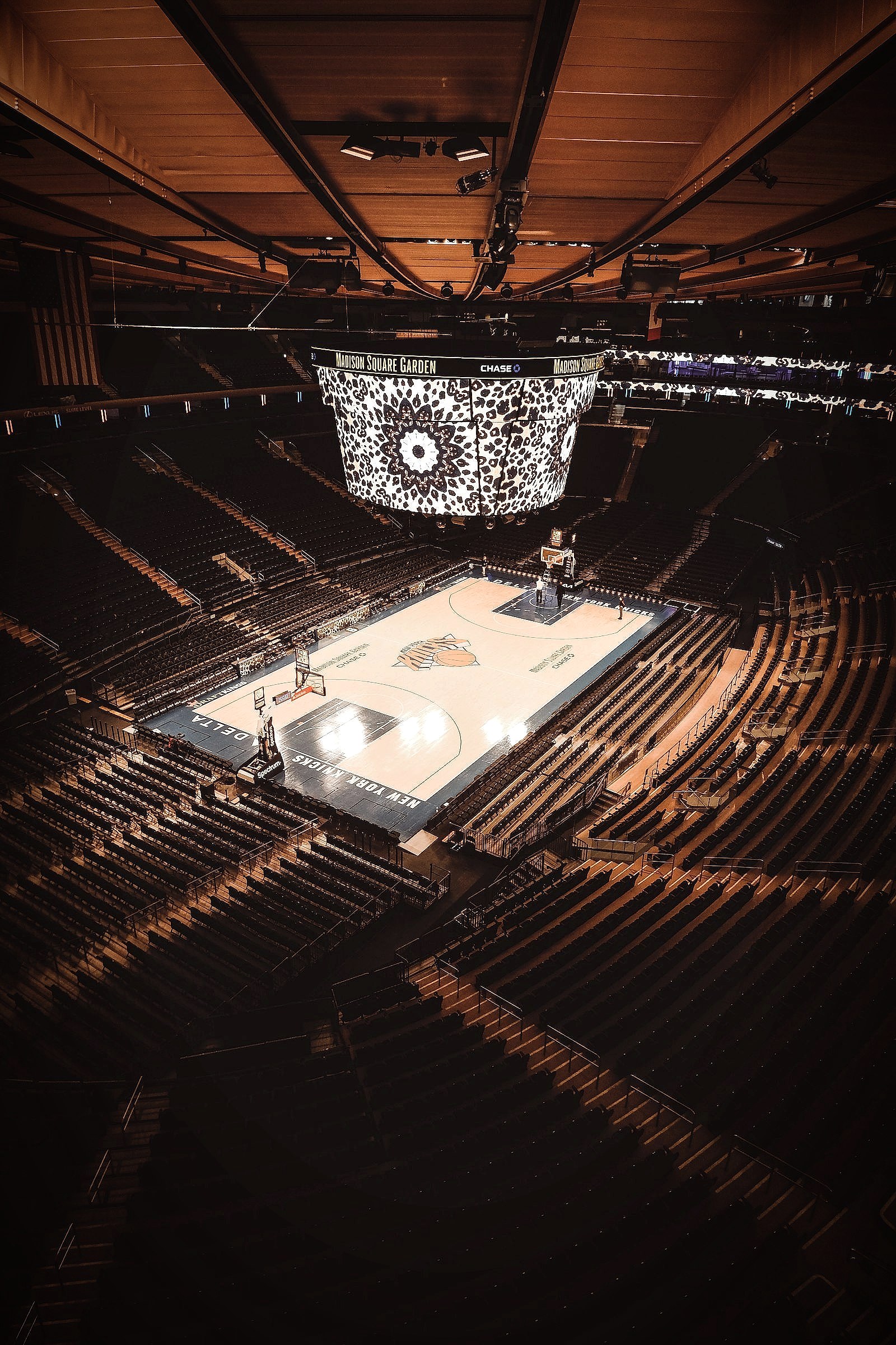 A basketball court inside a large arena filled with fans
