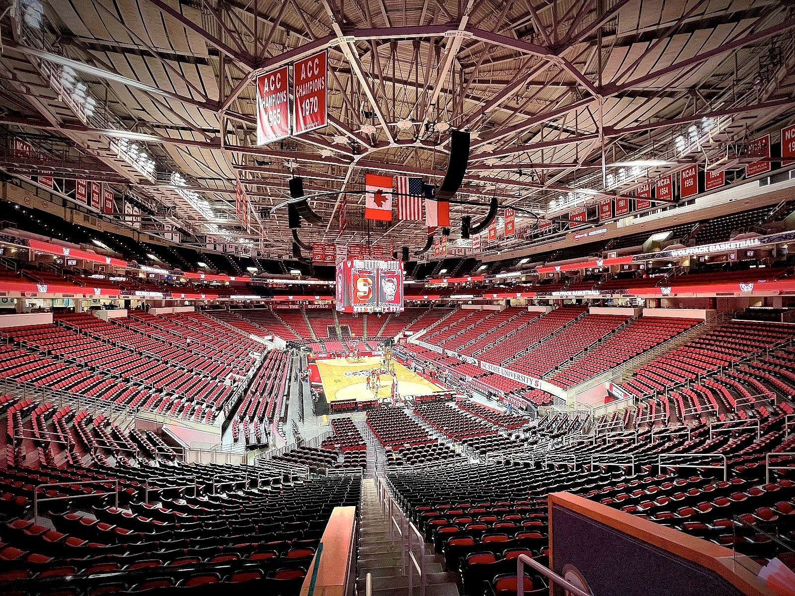 An empty NBA-style basketball arena with the lights on
